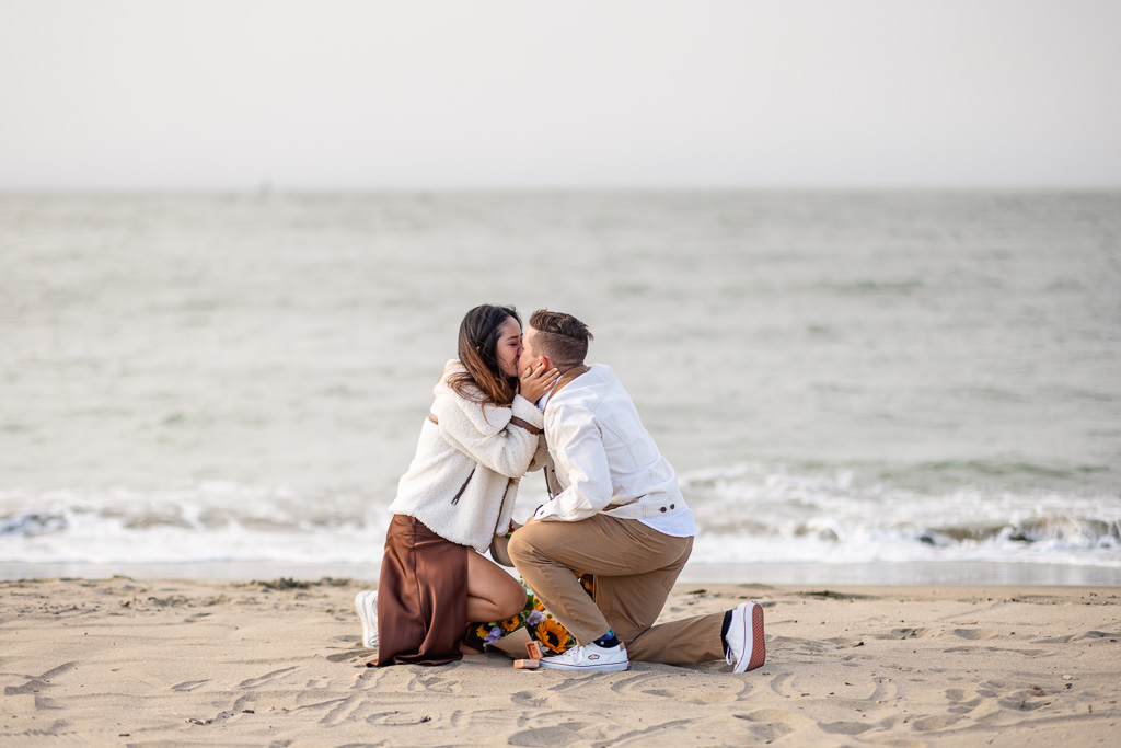 a kiss on the beach after proposing