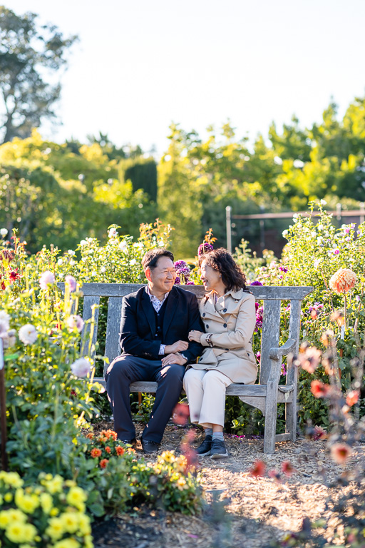 a middle-aged couple on a bench under the golden sun