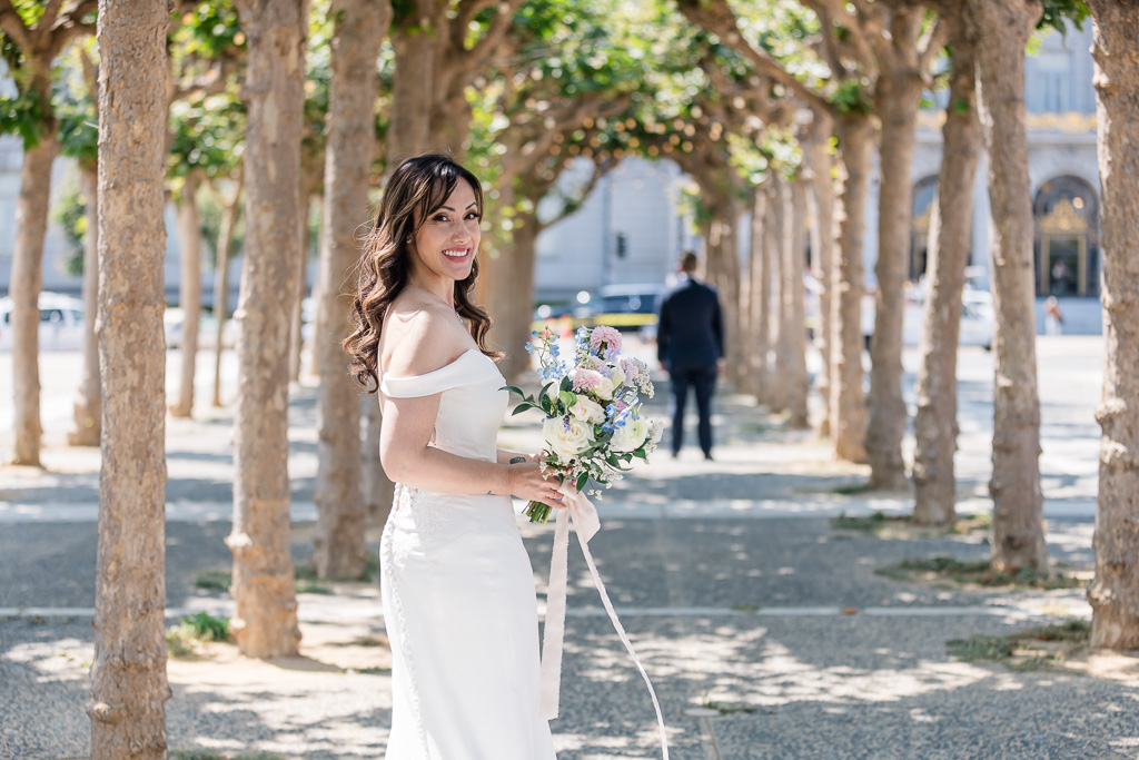 wedding day first look in the trees outside SF City Hall