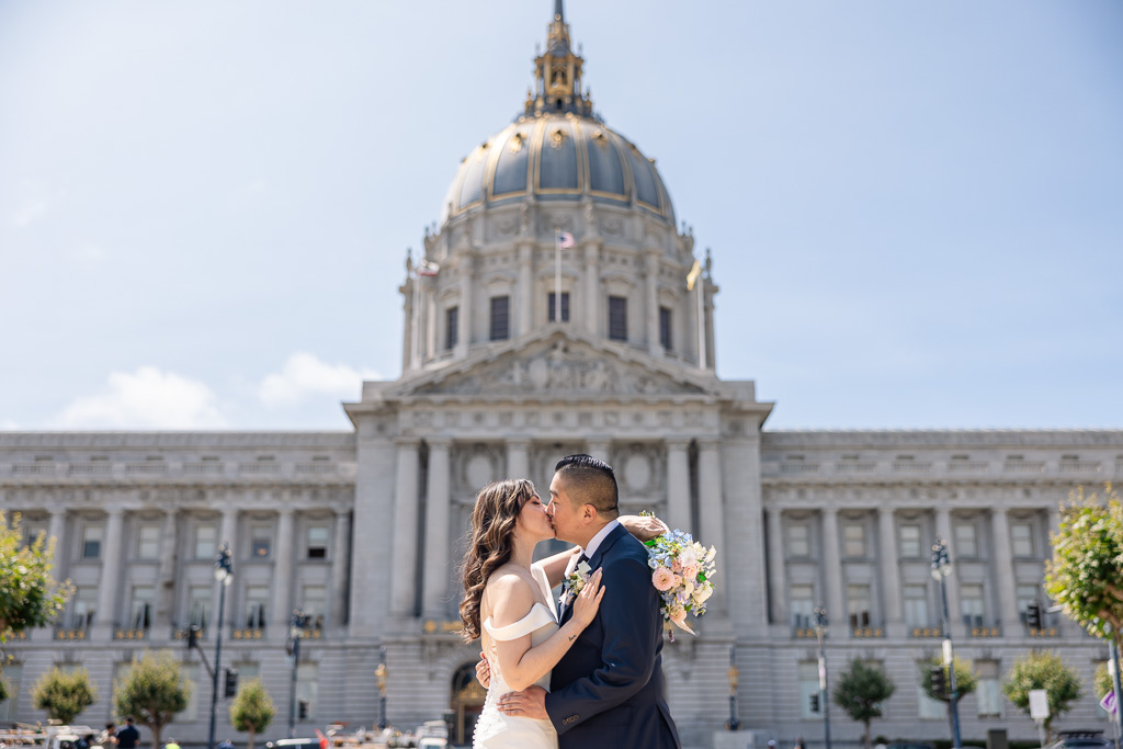 photo of bride and groom on wedding day outside San Francisco City Hall front