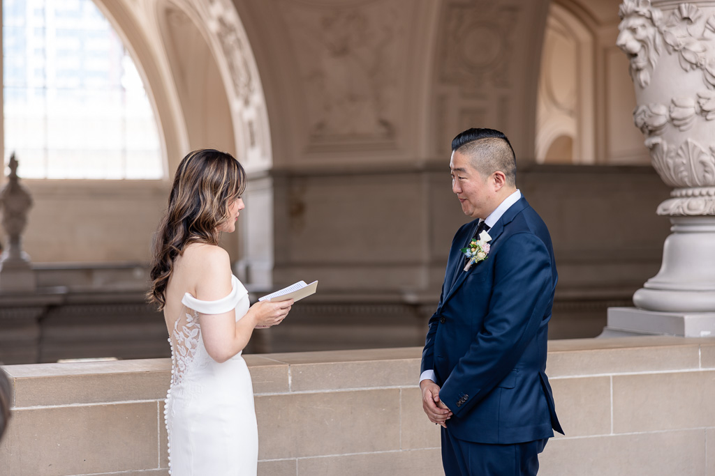 bride reading her personal vows to groom at City Hall