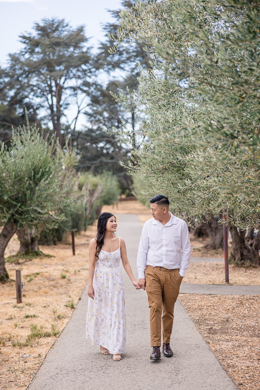 engagement photos walking along a park path