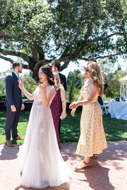 candid photo of the bride and groom with some wedding guests at cocktail hour