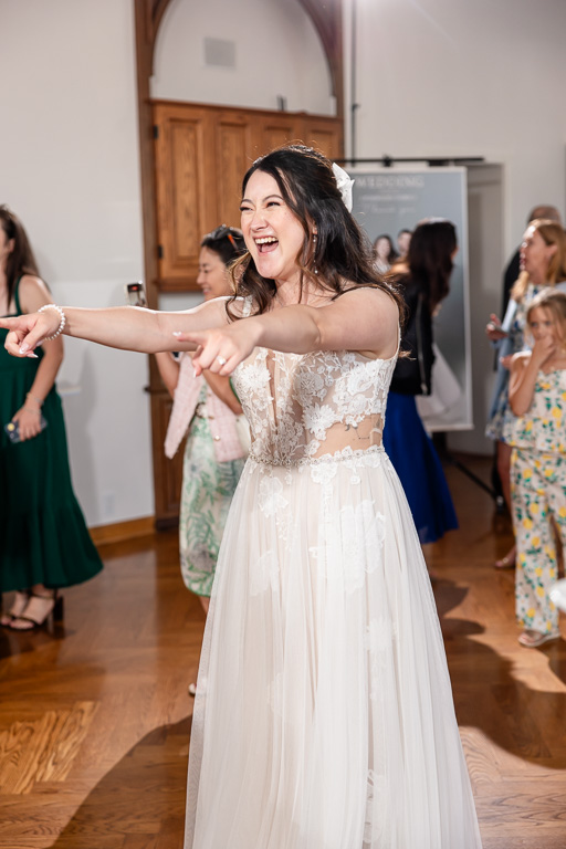 bride singing karaoke with the guests at the reception