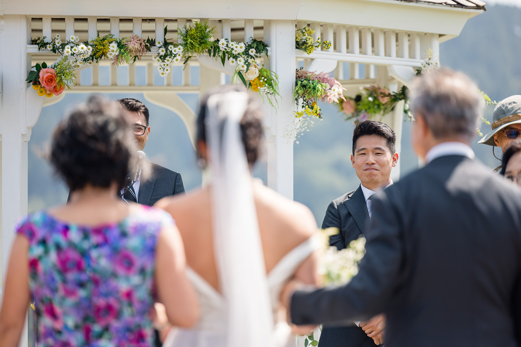 groom receiving bride at the end of the aisle