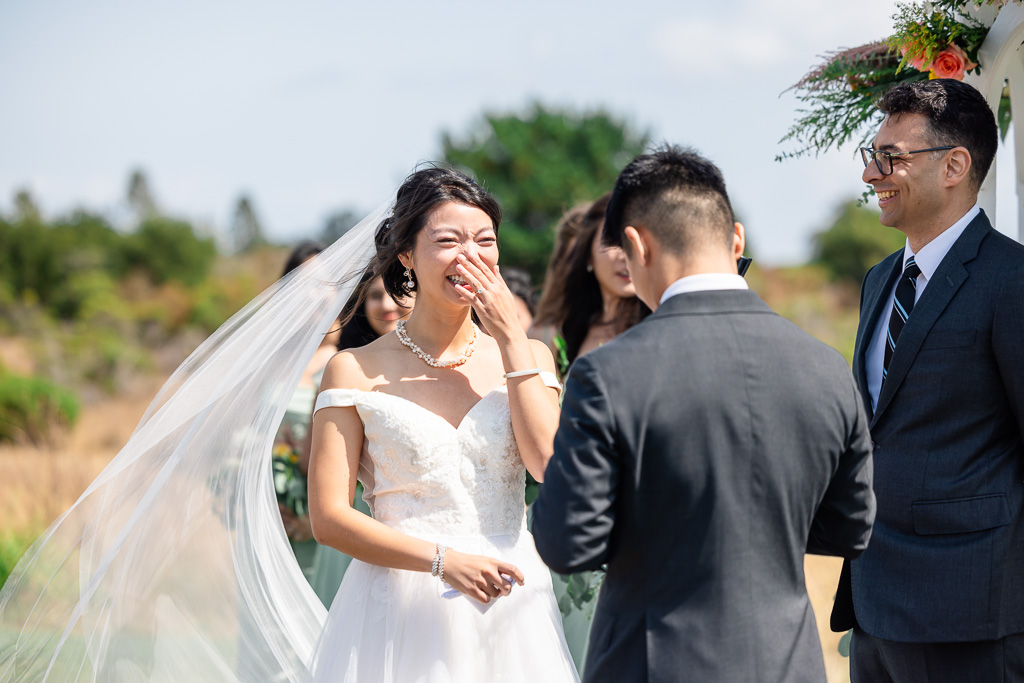 bride laughing as groom gives funny vows