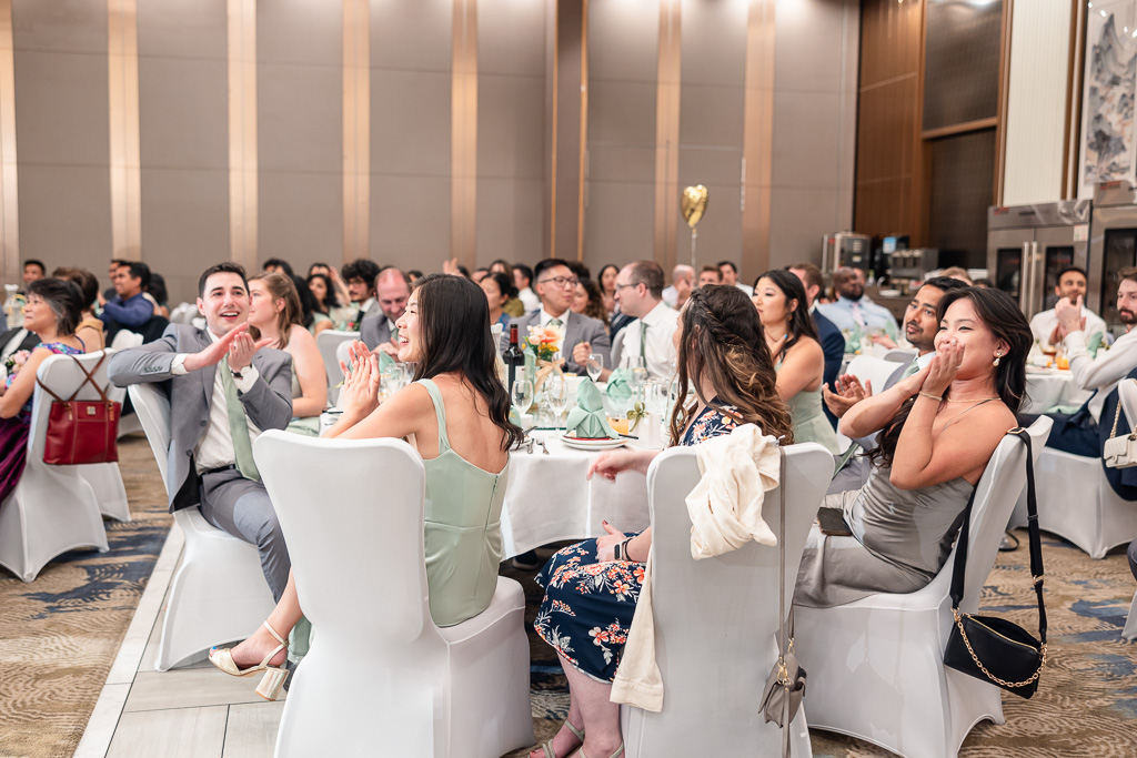 friends cheering and clapping for the newlyweds