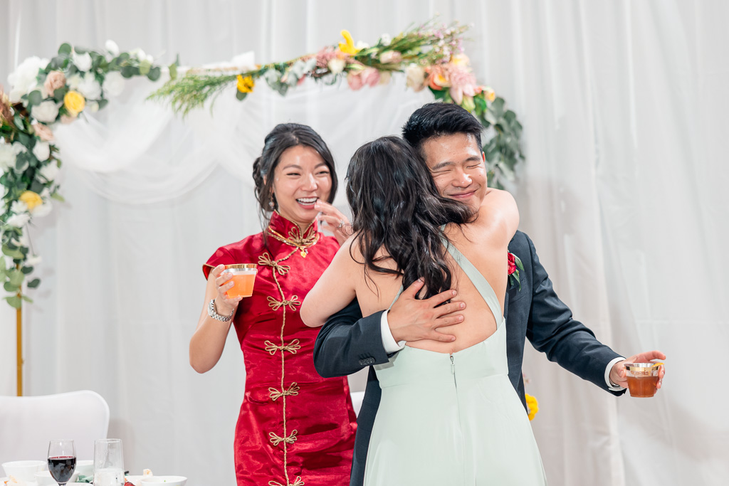 groom giving a hug to a speech giver