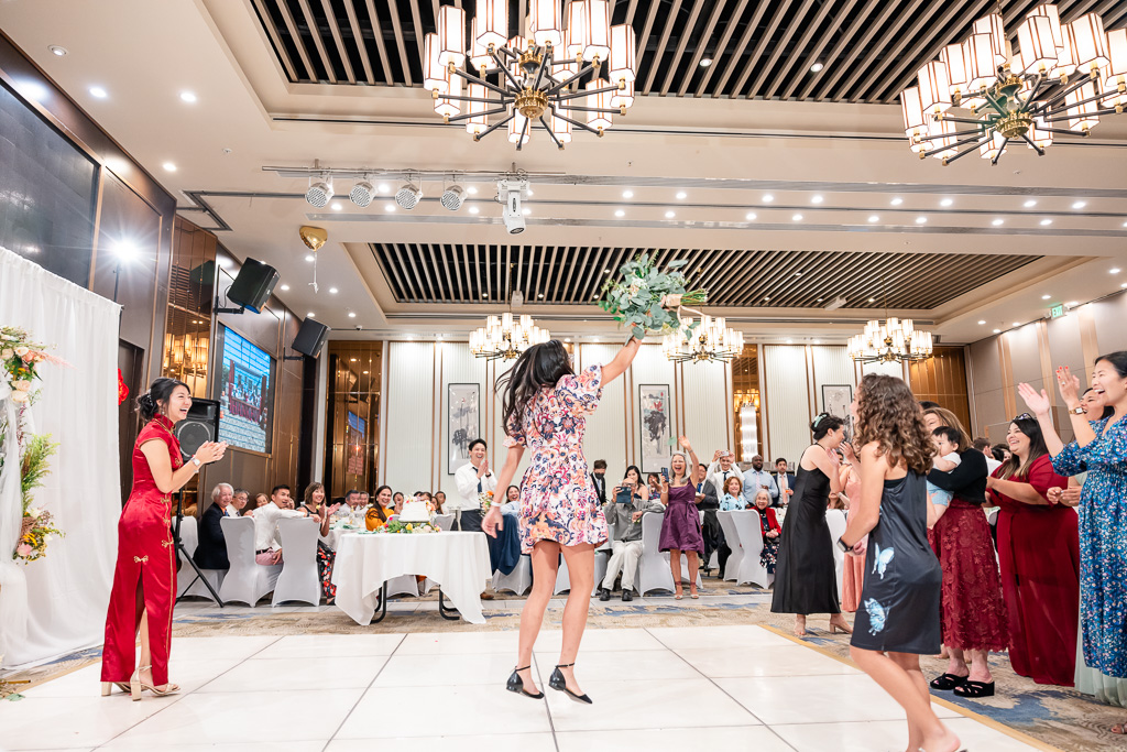 a very excited winner of the bouquet toss