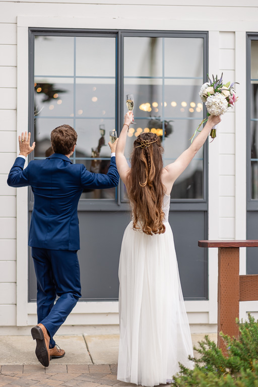 bride and groom jumping and dancing into the cocktail hour