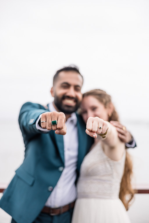 the bride and her friend showing off their somewhat matching rings