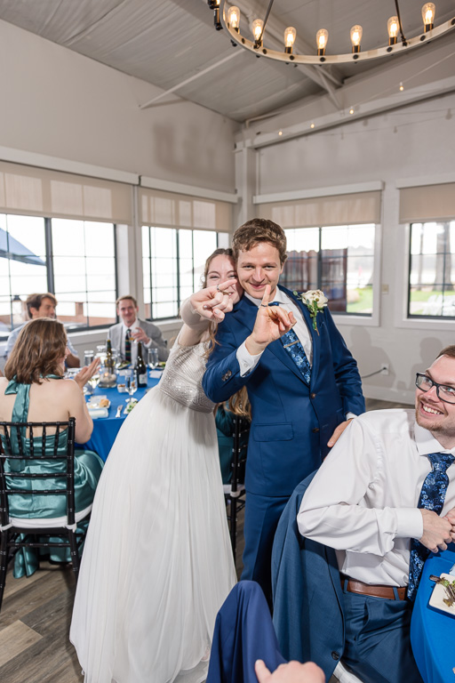 bride and groom showing their new rings