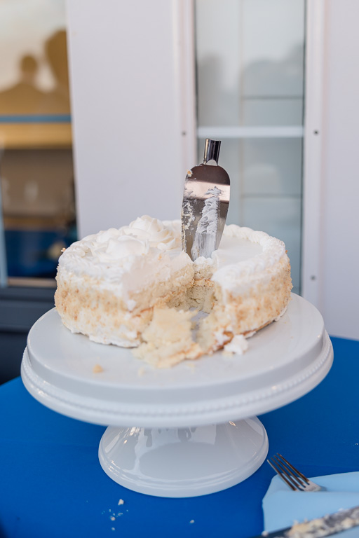 the remnants of the broken cake cutting knife sticking out of the cake