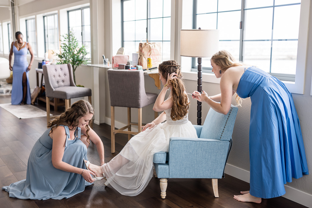 bride in upstairs getting ready room at Mavericks House with her bridesmaids