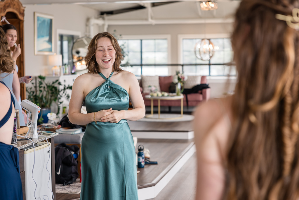 maid of honor looking at the bride in her dress