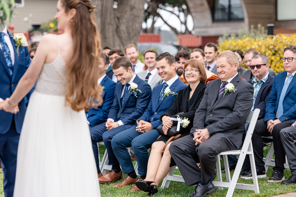 parents and groomsmen seated in first row