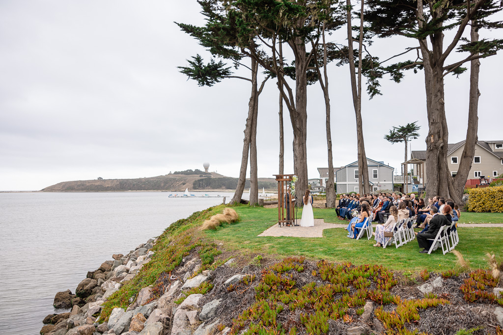 wide angle showing wedding ceremony on the coast by the ocean in Half Moon Bay