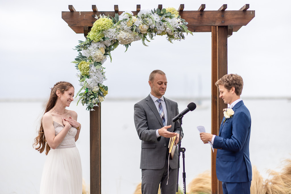 bride making an aww reaction while the groom delivers his heartfelt vows