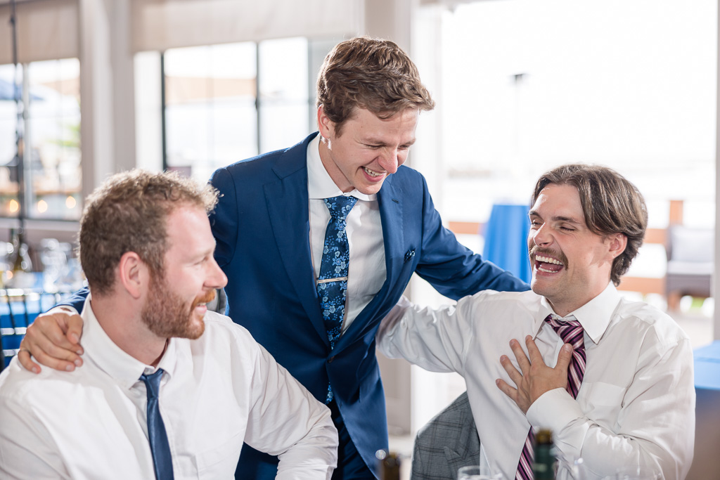 groom talking and laughing with his friends