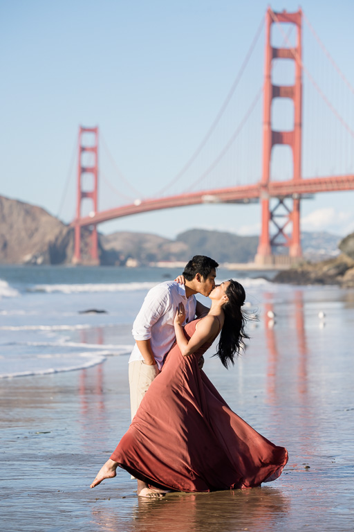 dramatic engagement photo in front of the Golden Gate Bridge