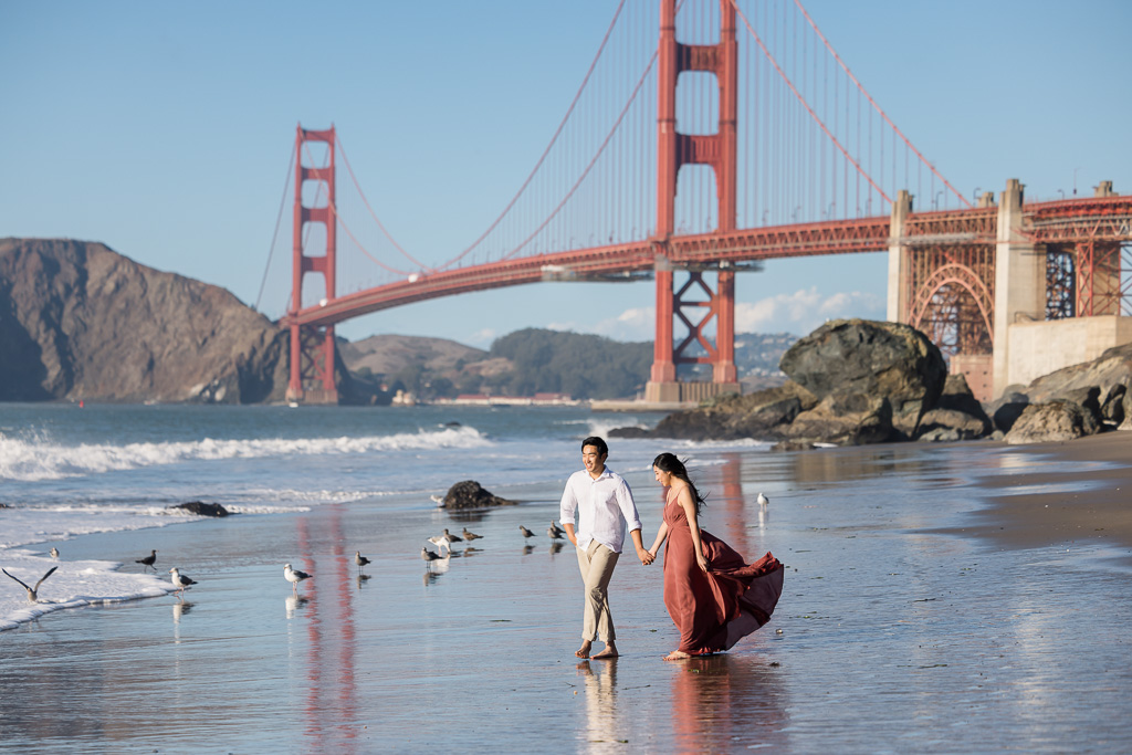 Golden Gate Bridge engagement photo with birds on the beach