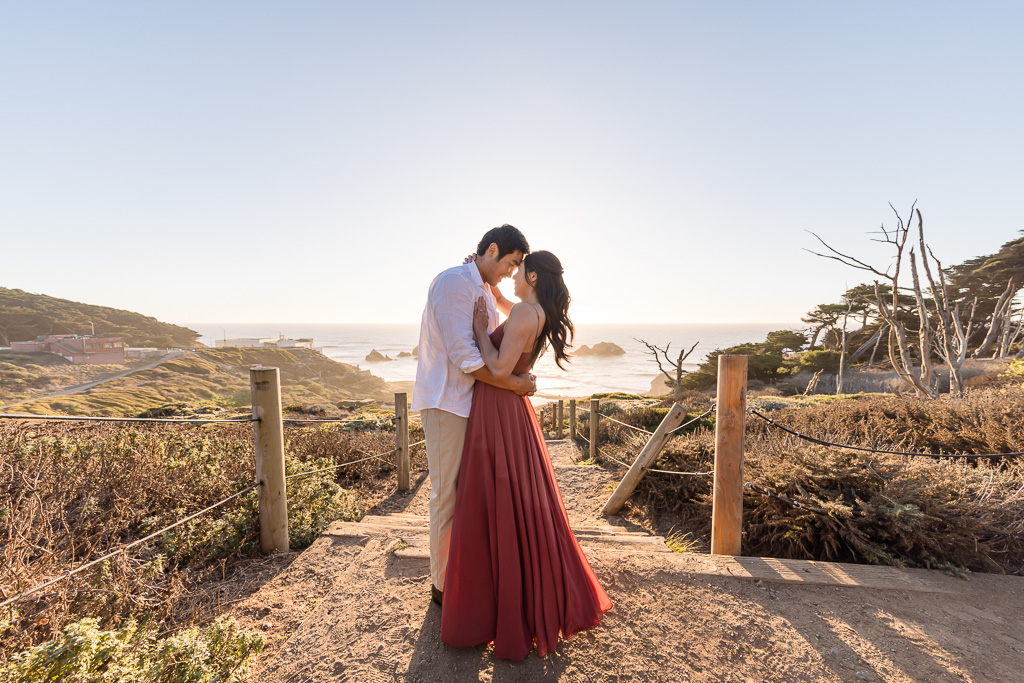 sunset engagement photo near ocean