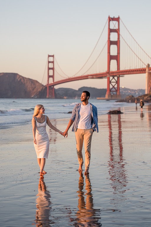 beach engagement photos at the Golden Gate Bridge with wet reflective sand