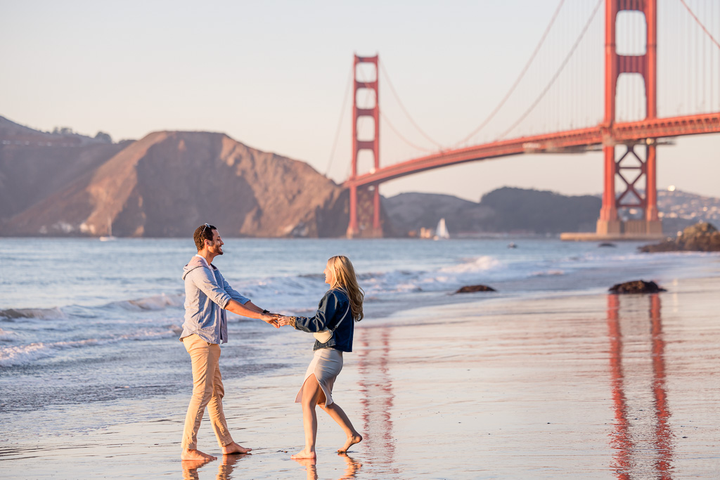 couple dancing in the water at the beach