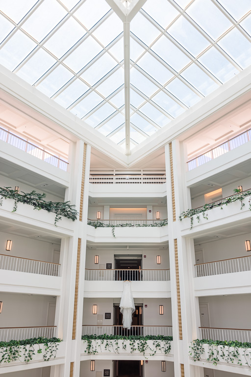 wedding gown hanging in hotel atrium