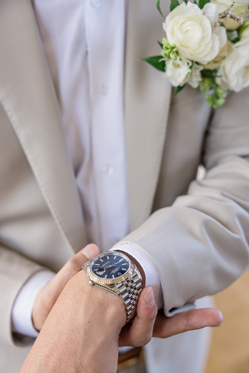 groom holding out his watch