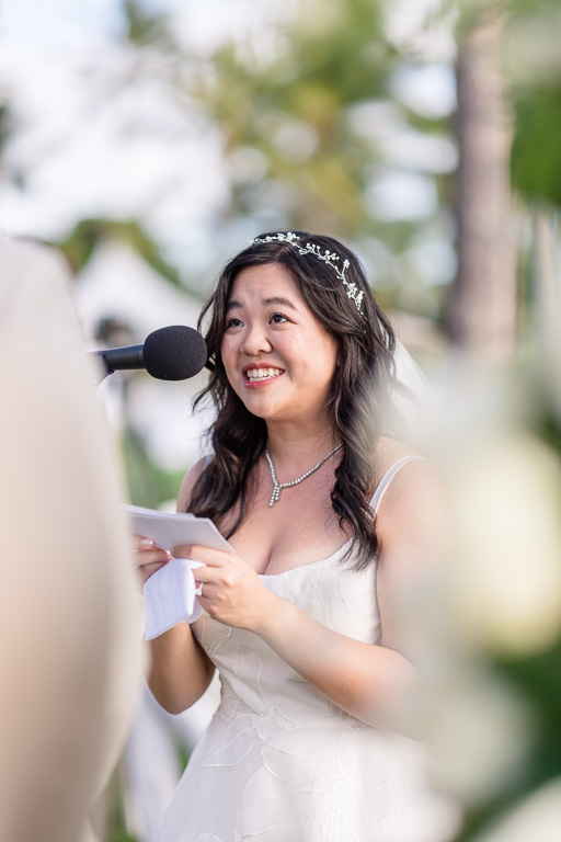 a very happy bride reading her handwritten wedding vows