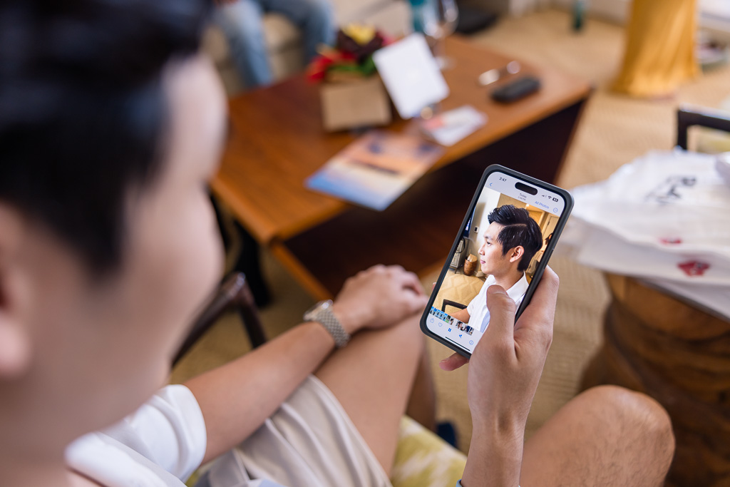 groom looking at a photo of his hair