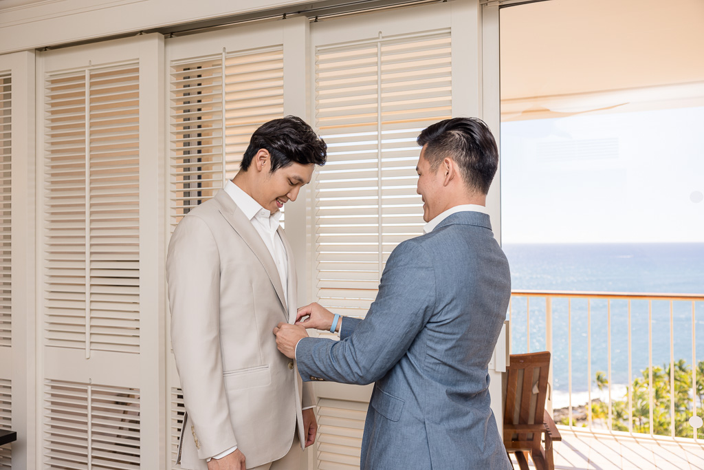 groom's brother helpnig him with suit