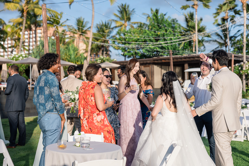 newlywed couple greeting guests at cocktail hour