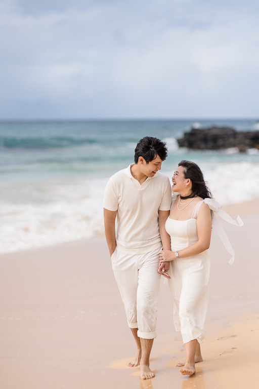 engagement photos in white attire on Sandy Beach