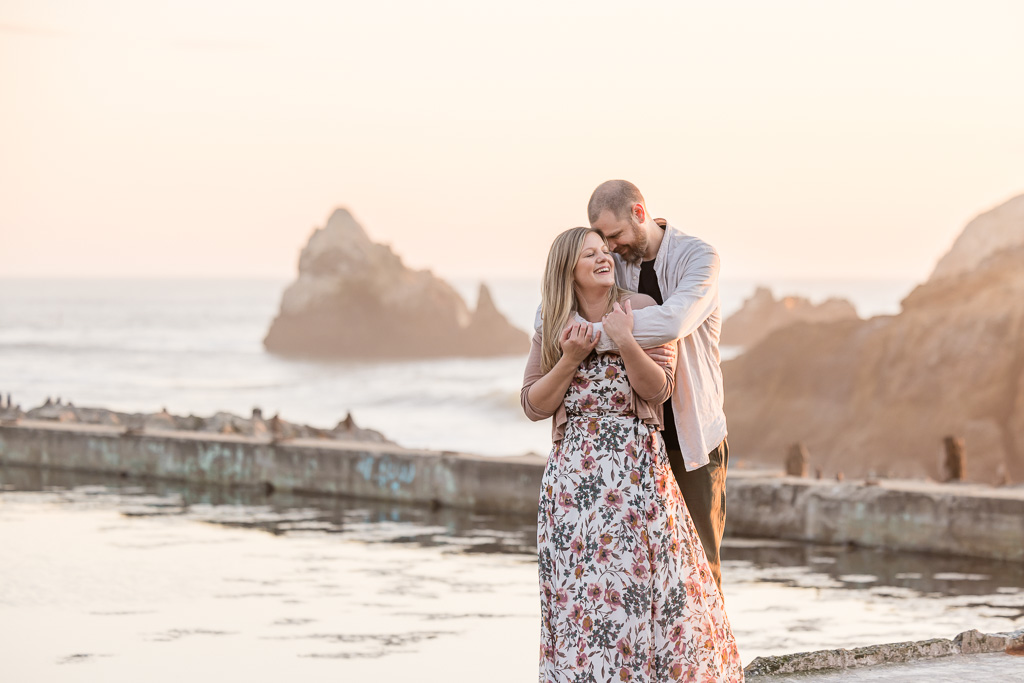 Sutro Baths engagement photos at sunset with a colorful pink sky