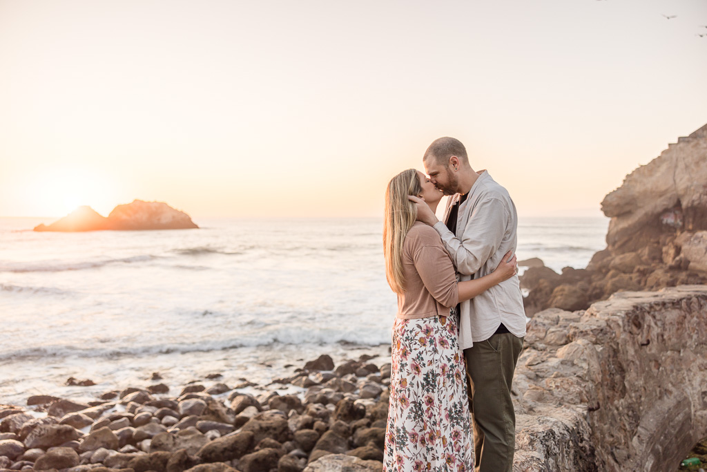 soft pink sunset ocean engagement photos