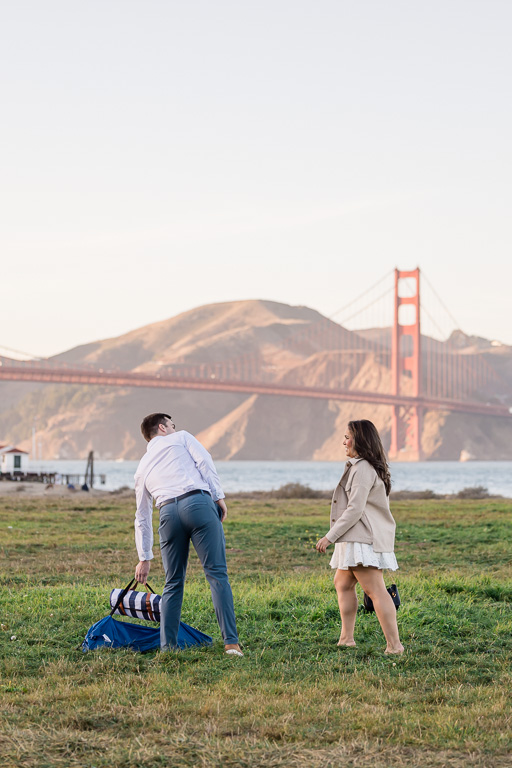 setting down some picnic items in front of the Golden Gate Bridge