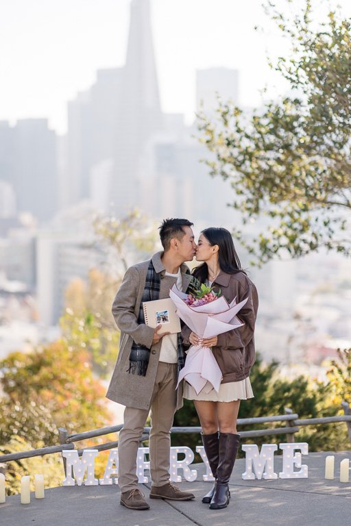 photo book and bouquet after she said yes to marriage proposal