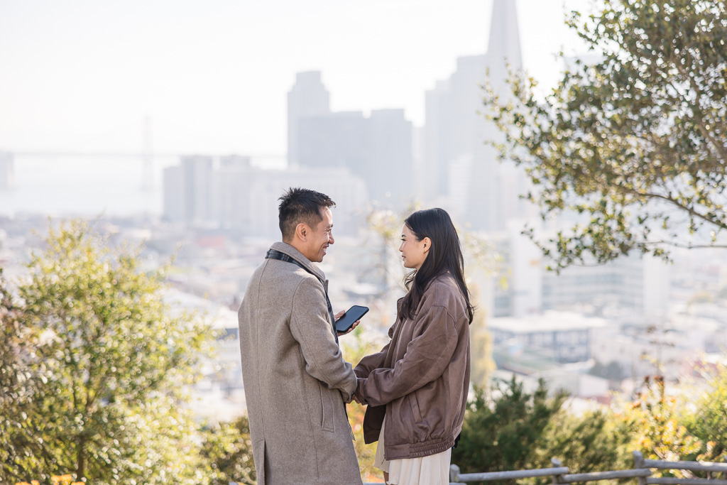 man reading a marriage proposal speech from his phone