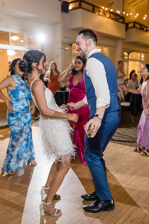 bride and groom dancing together at the end of the night