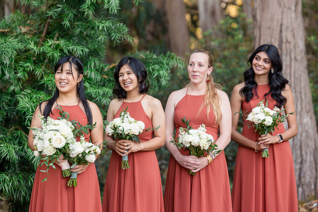 bridesmaids wearing matching burnt orange dresses