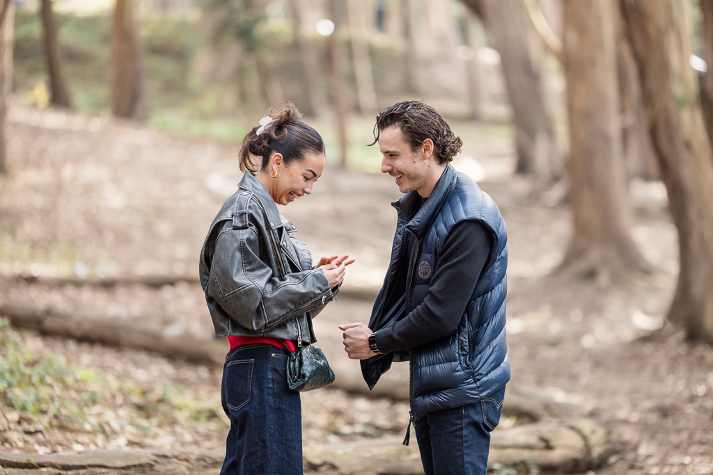 happy couple admiring the engagement ring together after proposal