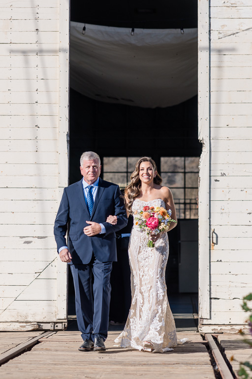 father of the bride walking the bride down the aisle