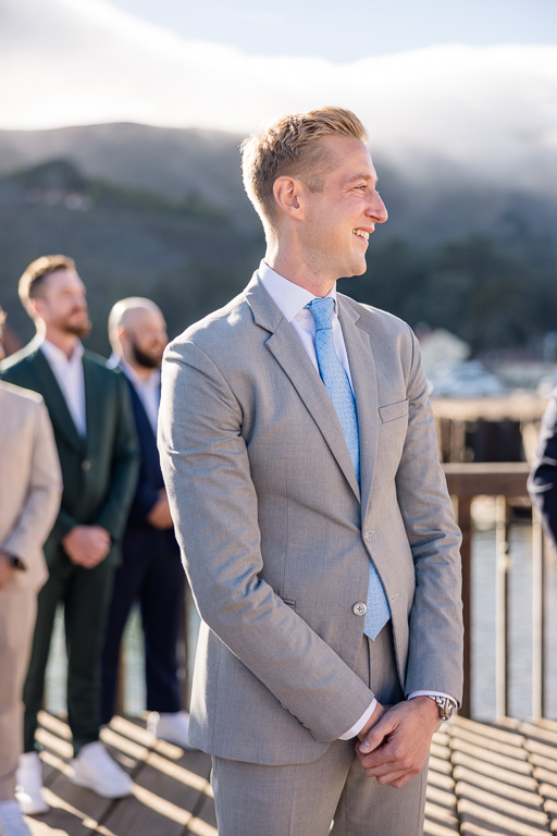 groom looking on as bride and dad walk up the aisle