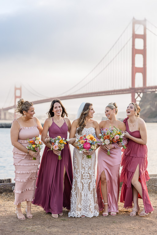 bride with pink and purple coordinated bridesmaids