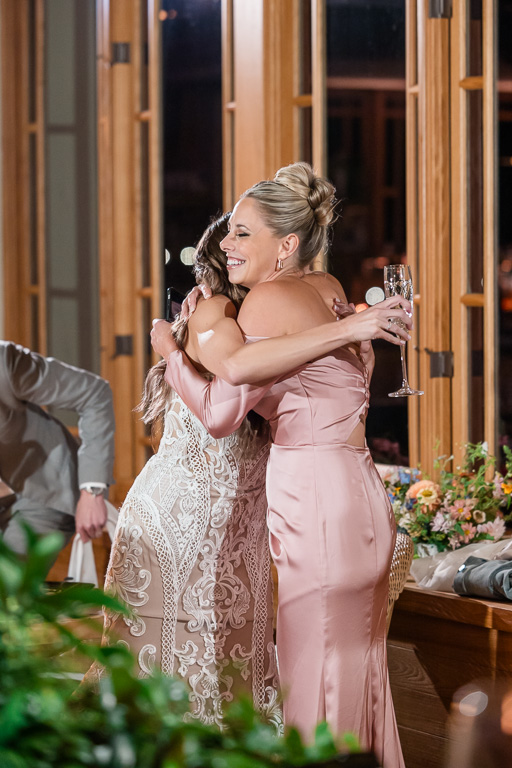 bride hugging bridesmaid after speech