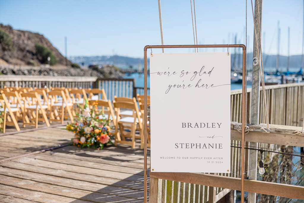 elegant wedding sign hanging on copper pipes