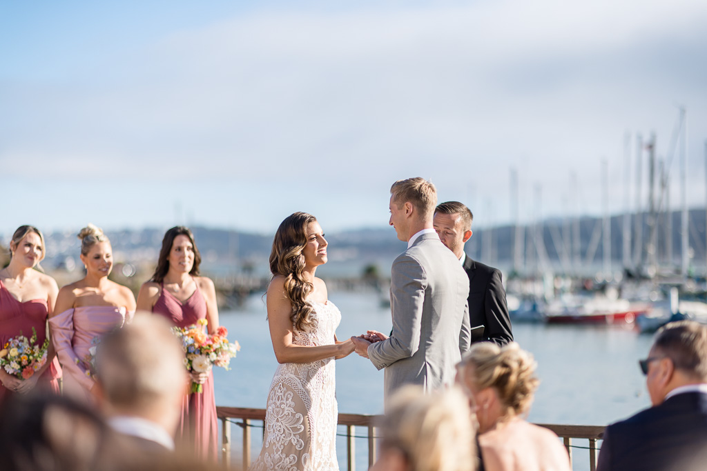 bride and groom holding hands during wedding ceremony