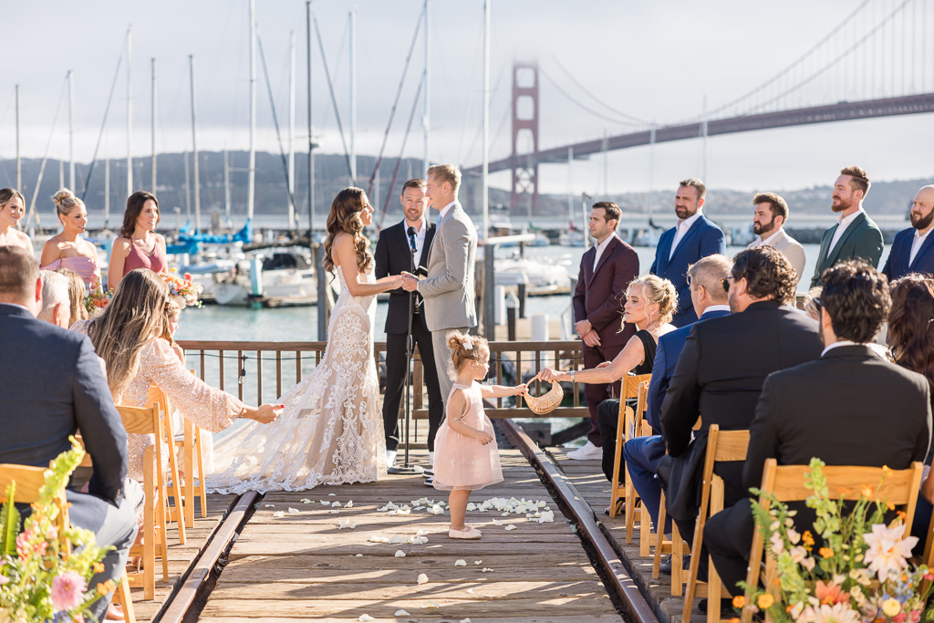 flower girl in the aisle during ceremony